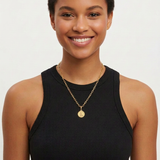 Female model 1 wearing the small St. Christopher medal necklace