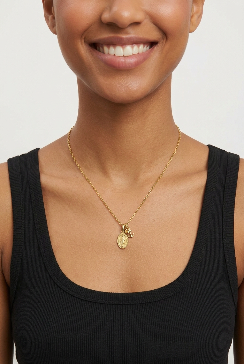 Female model wearing the petite oval Mary medal necklace