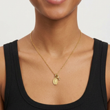 Female model wearing the petite oval Mary medal necklace
