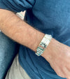 Solid sterling silver Cuban link ID bracelet with personalized 14 karat gold letters spell RICARDO